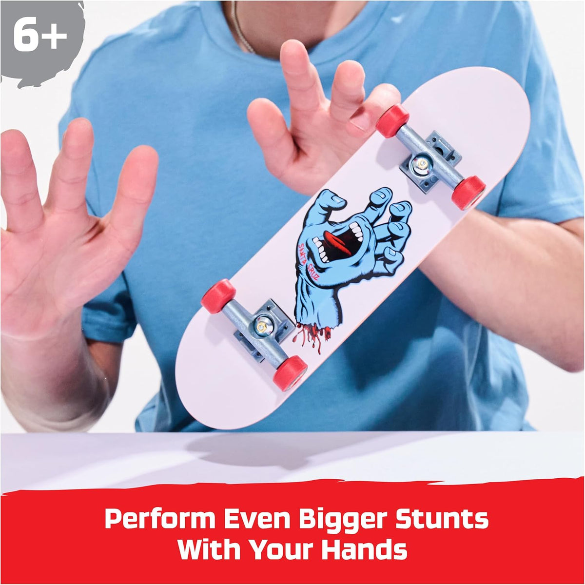 Fingerboard with a zombie design held by a child, with text encouraging bigger stunts.