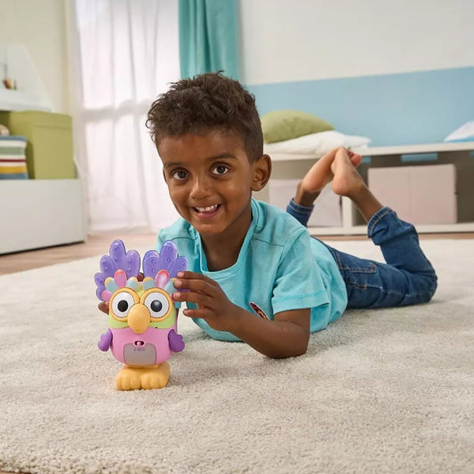 boy playing with multi-coloured toy character on carpet 