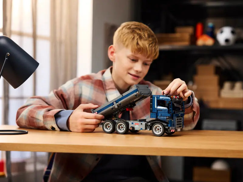 Child playing with the LEGO Technic Dump Truck