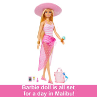 Blonde Barbie Doll with Swimsuit Beach-Themed showing off her stacked bracelet and beach accessories.
