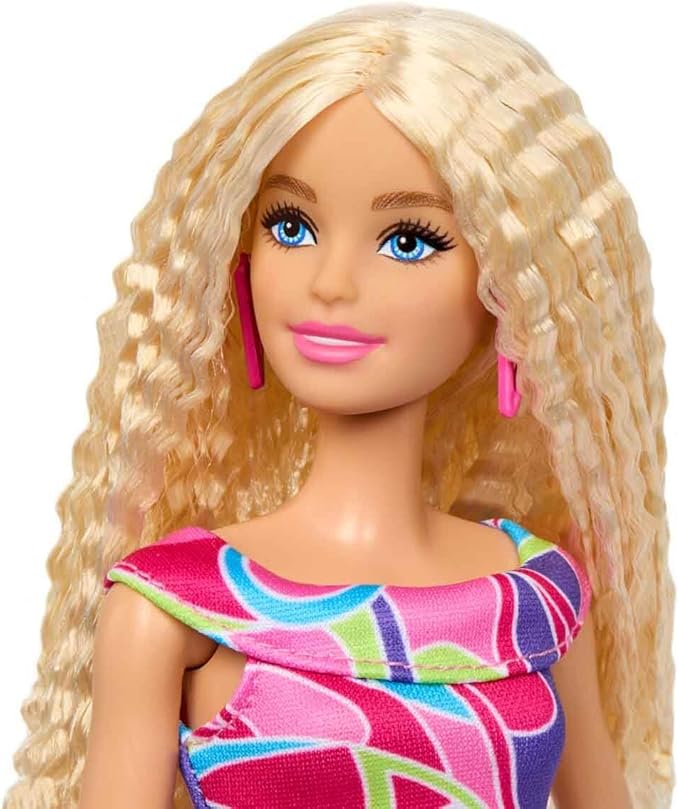 Celebrate Barbie’s iconic 65th anniversary with Doll #223, featuring a blonde wavy hairstyle and fashionable Totally Hair-inspired attire.
