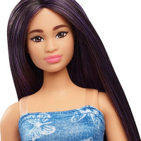 The vibrant Barbie Fashionistas Doll #231, showcasing purple hair and a chic butterfly-print dress with a pink belt.
