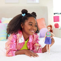 Barbie Fashionistas Doll #232 has bright red hair, sporty attire, and trendy sneakers, perfect for imaginative play.
