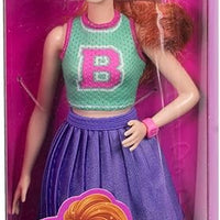 Barbie Fashionistas Doll #232 features red hair, a fun sporty top, and a stylish purple skirt with sneakers and a watch.
