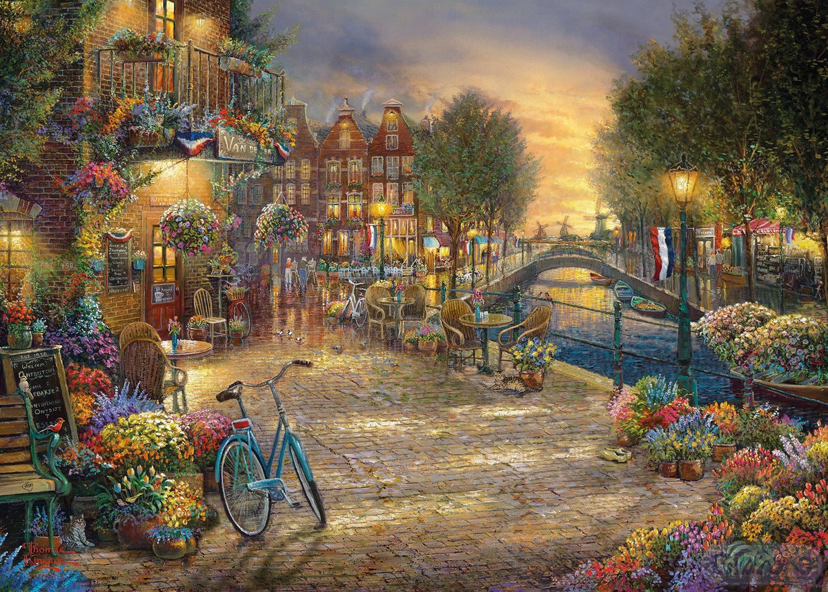 Enjoy the beauty of Amsterdam with the Gibsons - Amsterdam Café 1000 Piece Jigsaw Puzzle, featuring a canal-side café.
