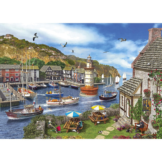 "1000-piece Gibsons - Lighthouse Bay puzzle with a tranquil seaside village scene."
