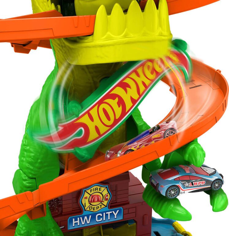 Firetruck zooming through the Hot Wheels T Rex Blaze Battle adventure track.
