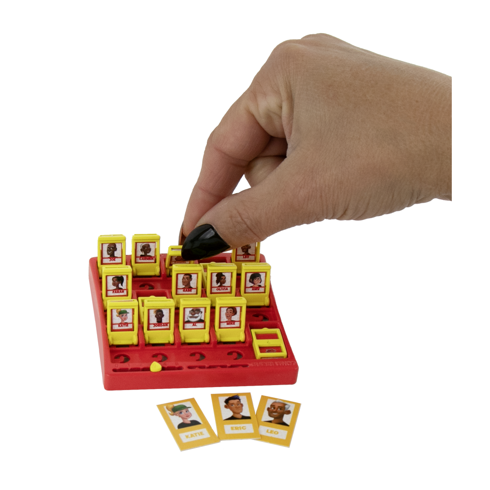 Hand flipping a tile on the tiny Guess Who? board to show its size