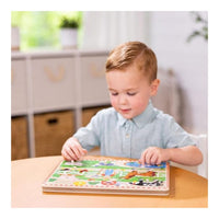 boy playing with sound puzzle at a table