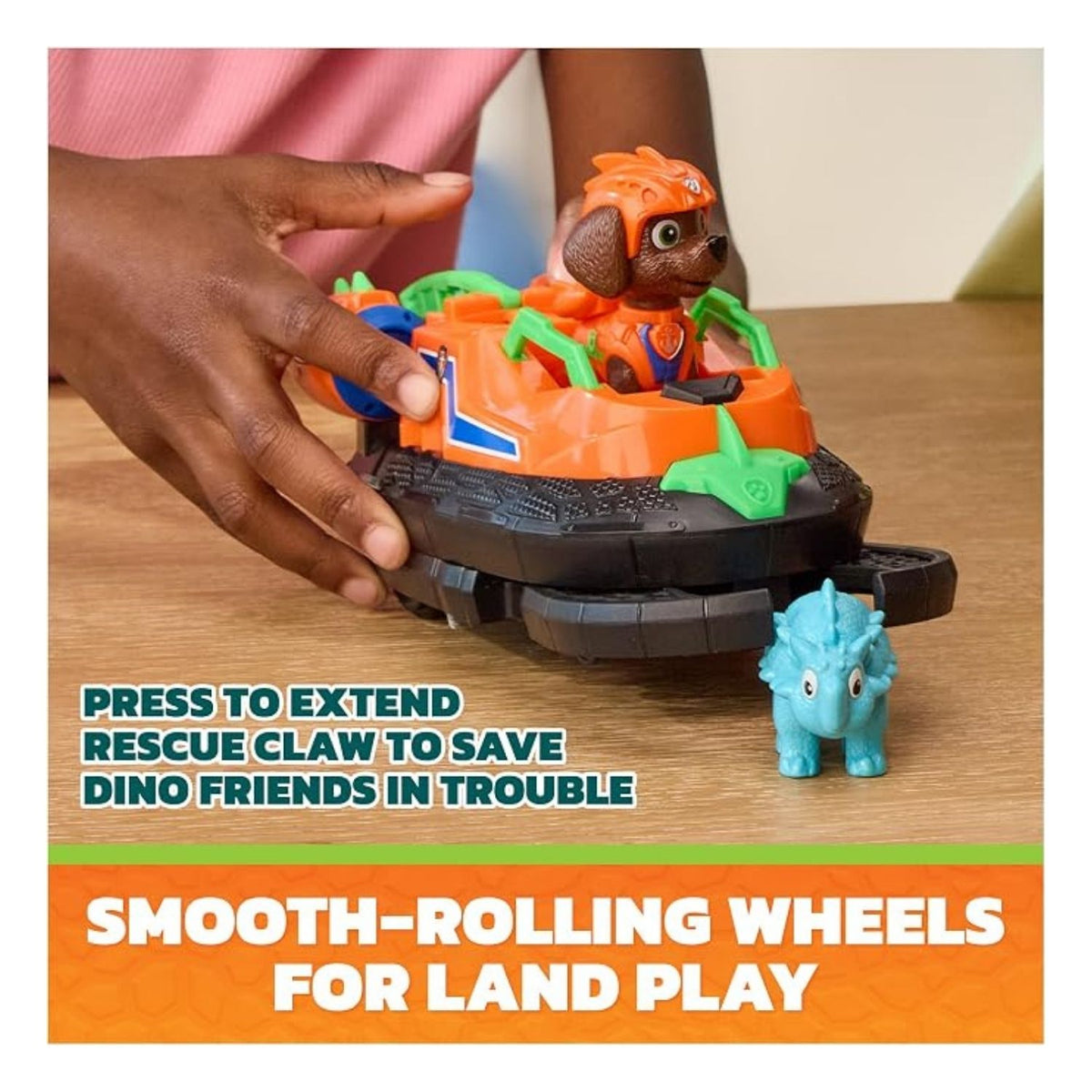 toy is being played with on the table with writing beneath as a graphic. 