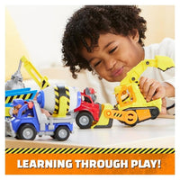 Child playing with multiple construction vehicles from the collection.
