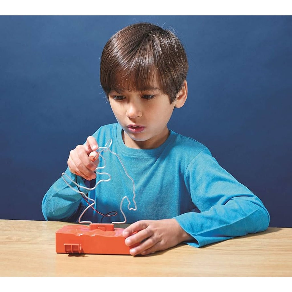 boy playing with t rex buzz wire game 