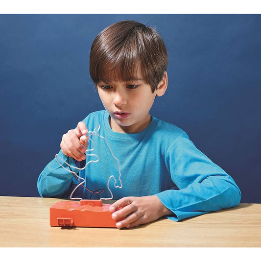 boy playing with t rex buzz wire game 