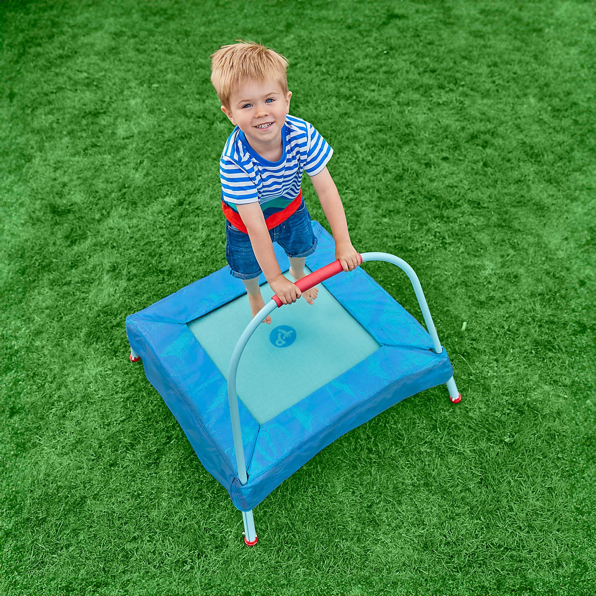 above view of child bouncing on trampoline 