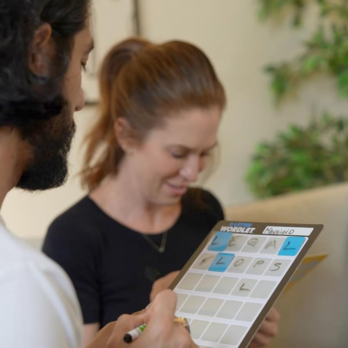 man and woman playing wordlet game 