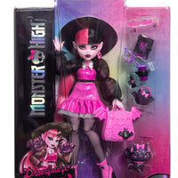 pink and black doll in packaging 