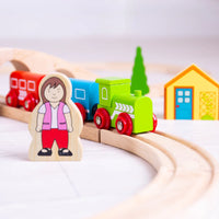close up of wooden female characeter and green wooden train 