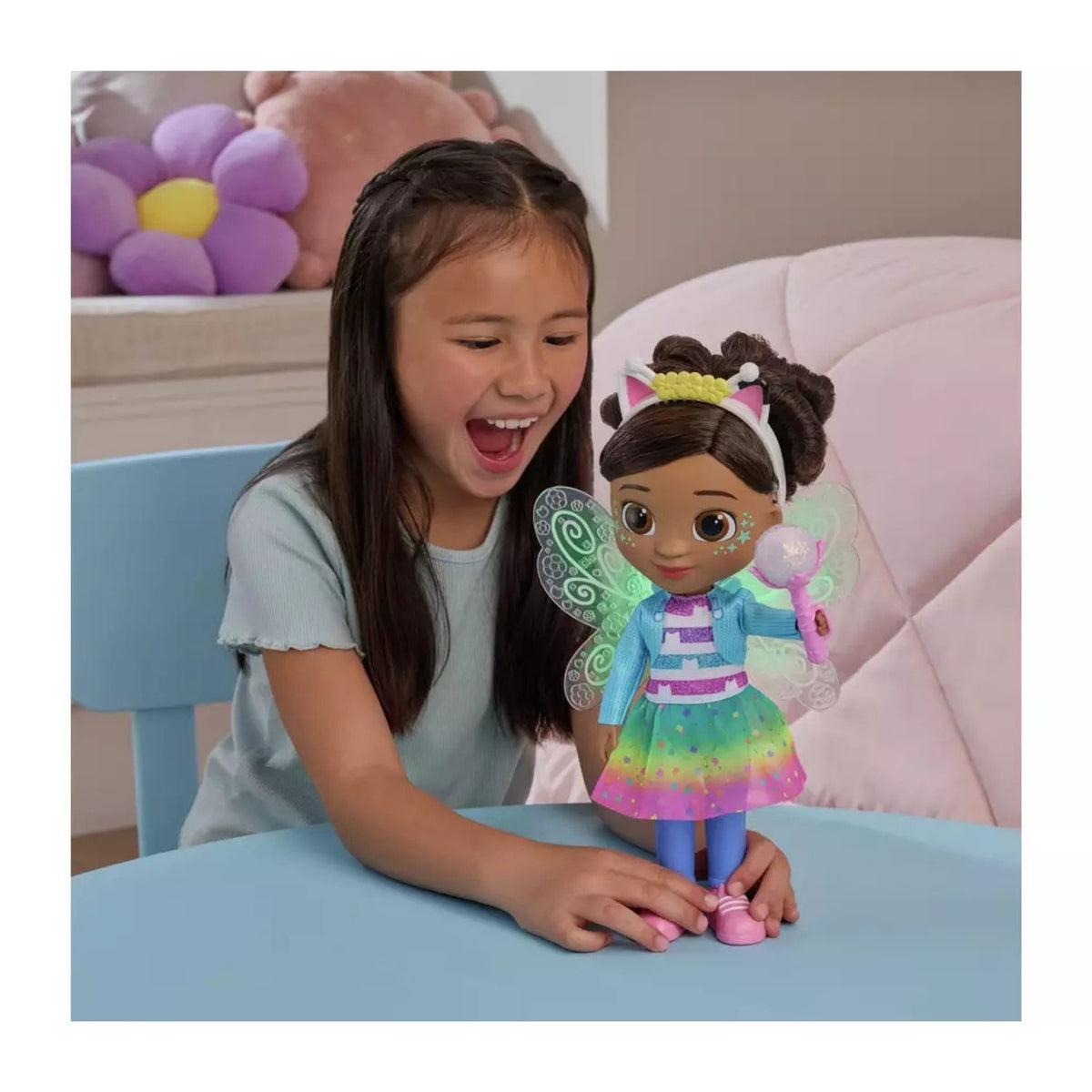 Child playing with Gabby Doll at table