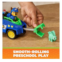 PAW patrol vehicle figurine on wooden table as someone plays with it 