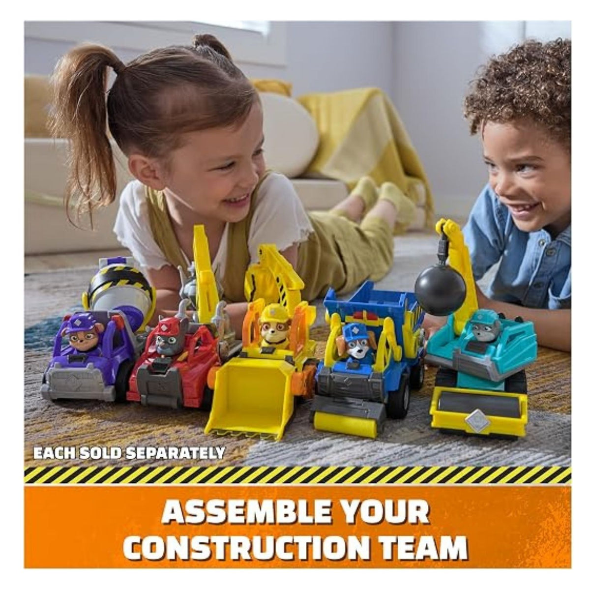 Two children playing on the floor with the whole Paw Patrol construction playset.