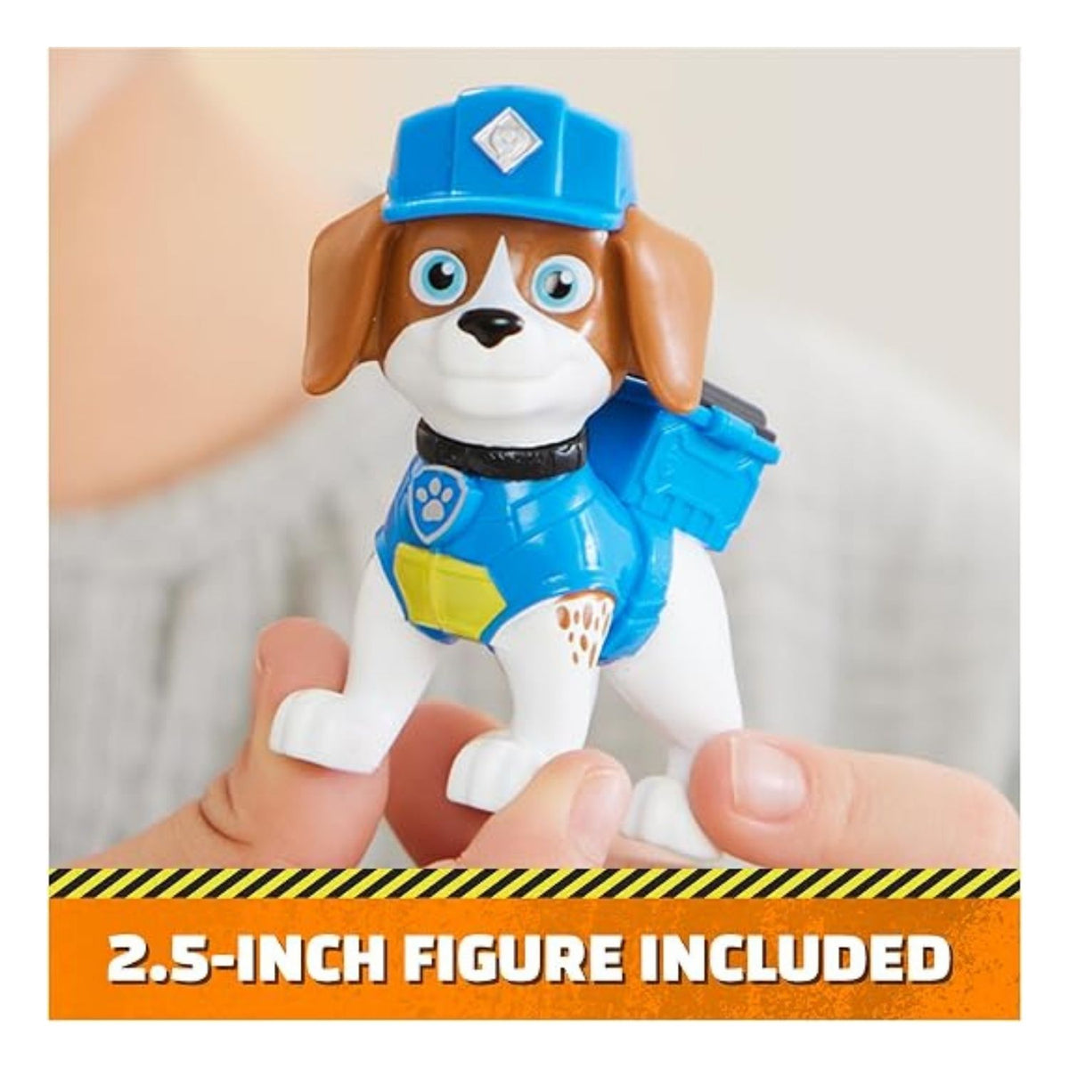 Small paw patrol figurine being held up.