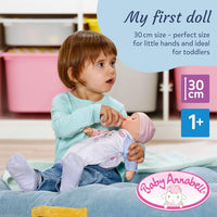 toddler playing with baby annabell doll