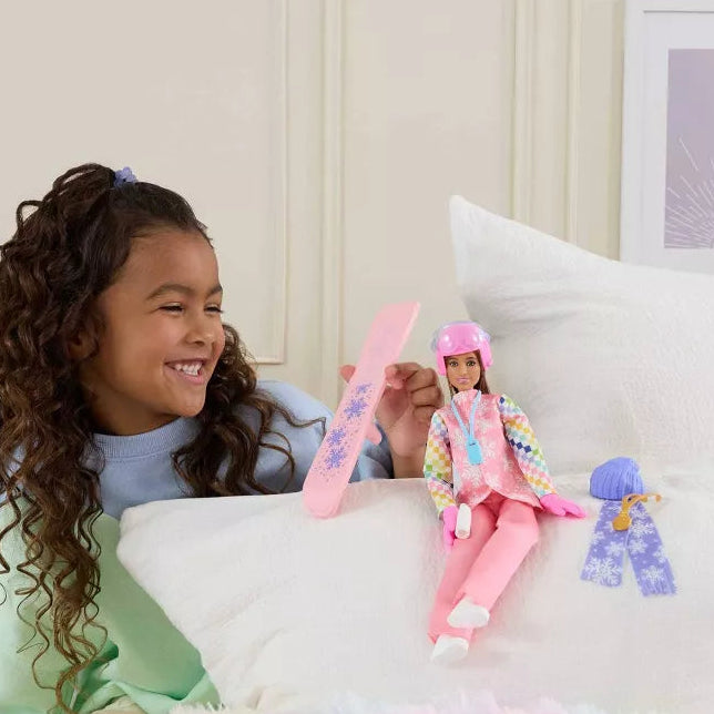 girl playing with barbie snowboarder 