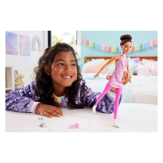 girl playing with figure skater doll 