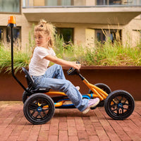 girl on go-kart with flashing light pole attached 