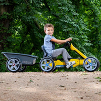 boy on go kart with trailer attached 