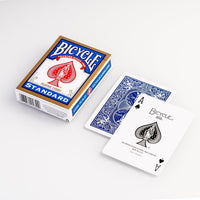 red and blue playing cards laid flat on white surface 