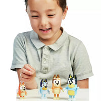 young boy playing with four dog mini figures 