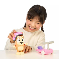 girl playing with bingo and scooter toy 