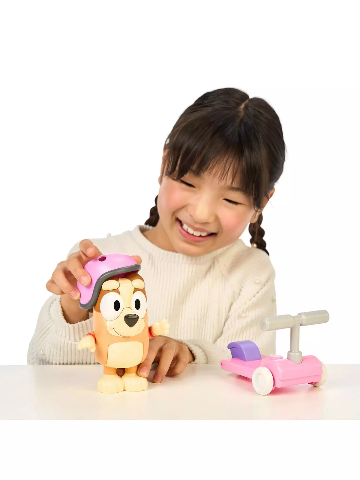girl playing with bingo and scooter toy 