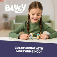 girl playing with bluey figurines 