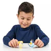 young boy playing with two dog mini figures on white background 