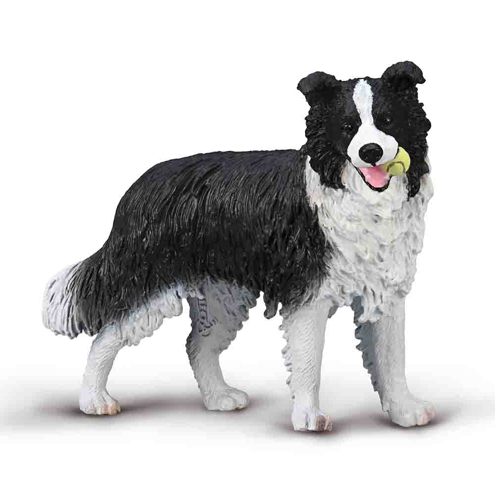 Black and white fluffy dog figurine with yellow ball in its mouth