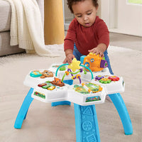 baby playing with brightly coloured activity table in living room 