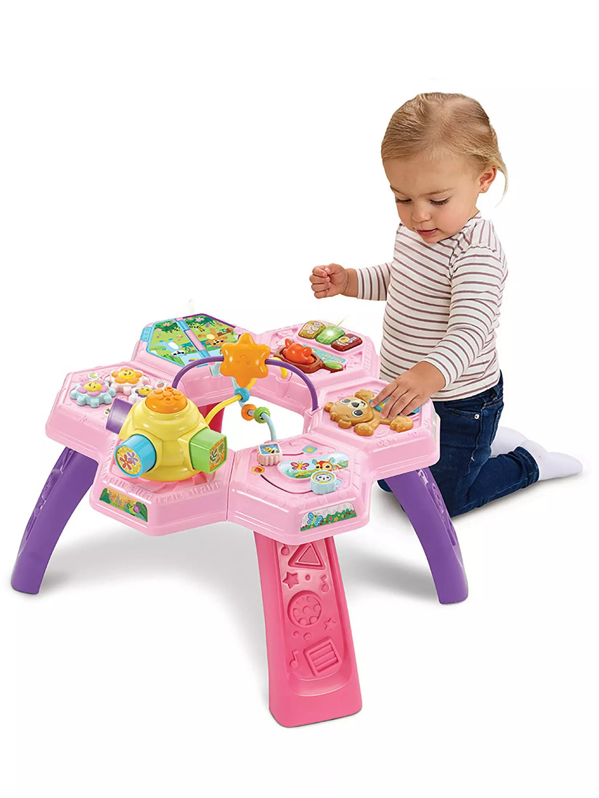 toddler kneeling playing with bright pink activity table on white background 