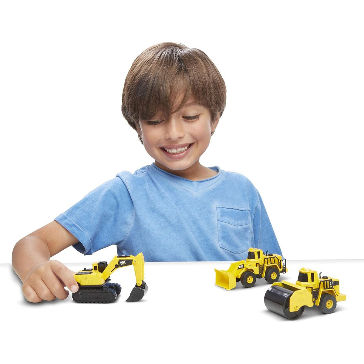 child playing with die cast construction vehicle 