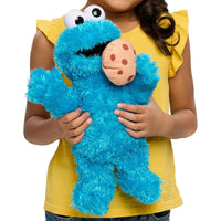 girl holding cookie monster plush 