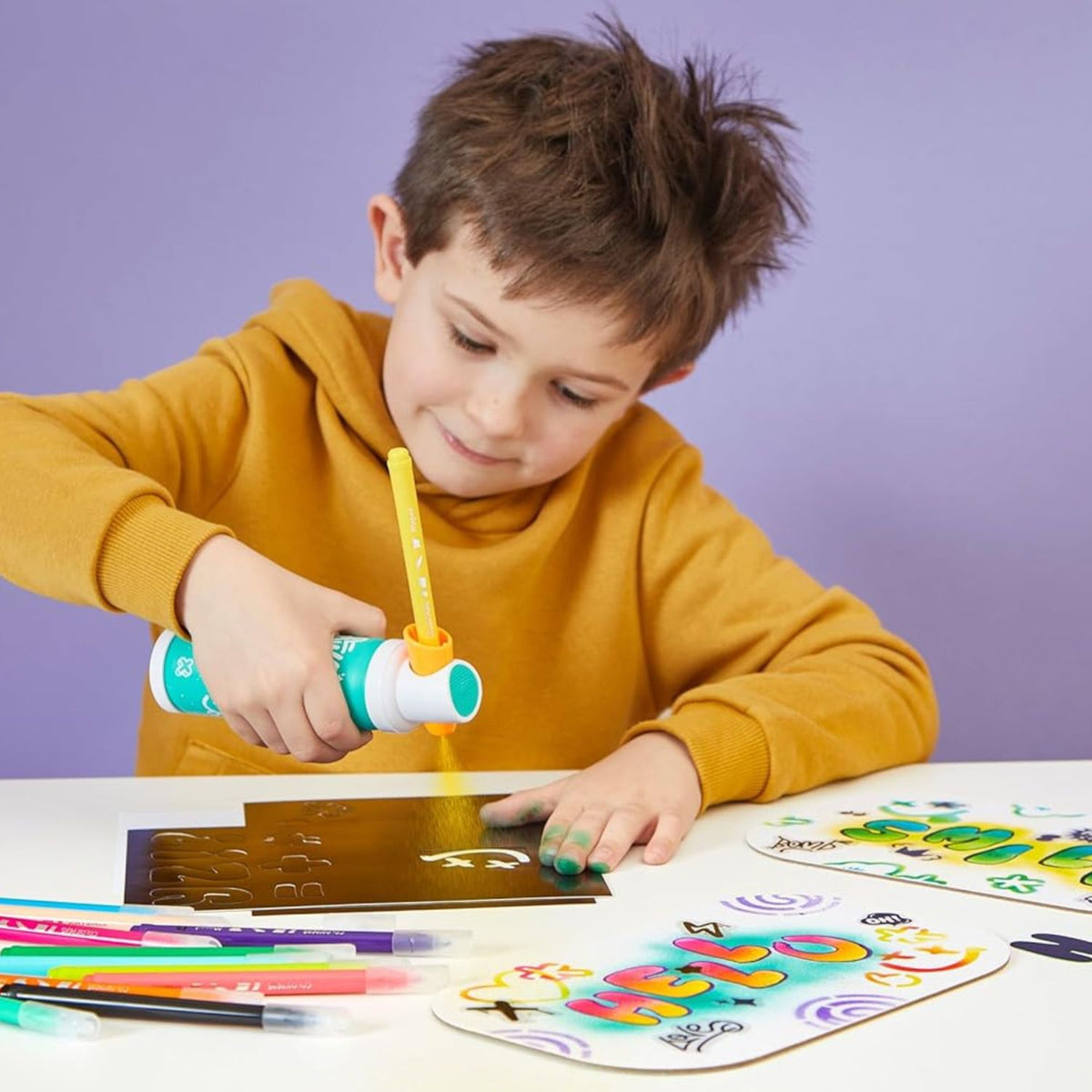 boy playing with airbrush maker 