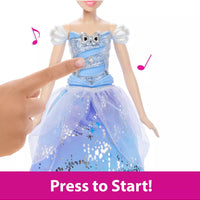 hand pressing button on doll in blue dress to make music play 