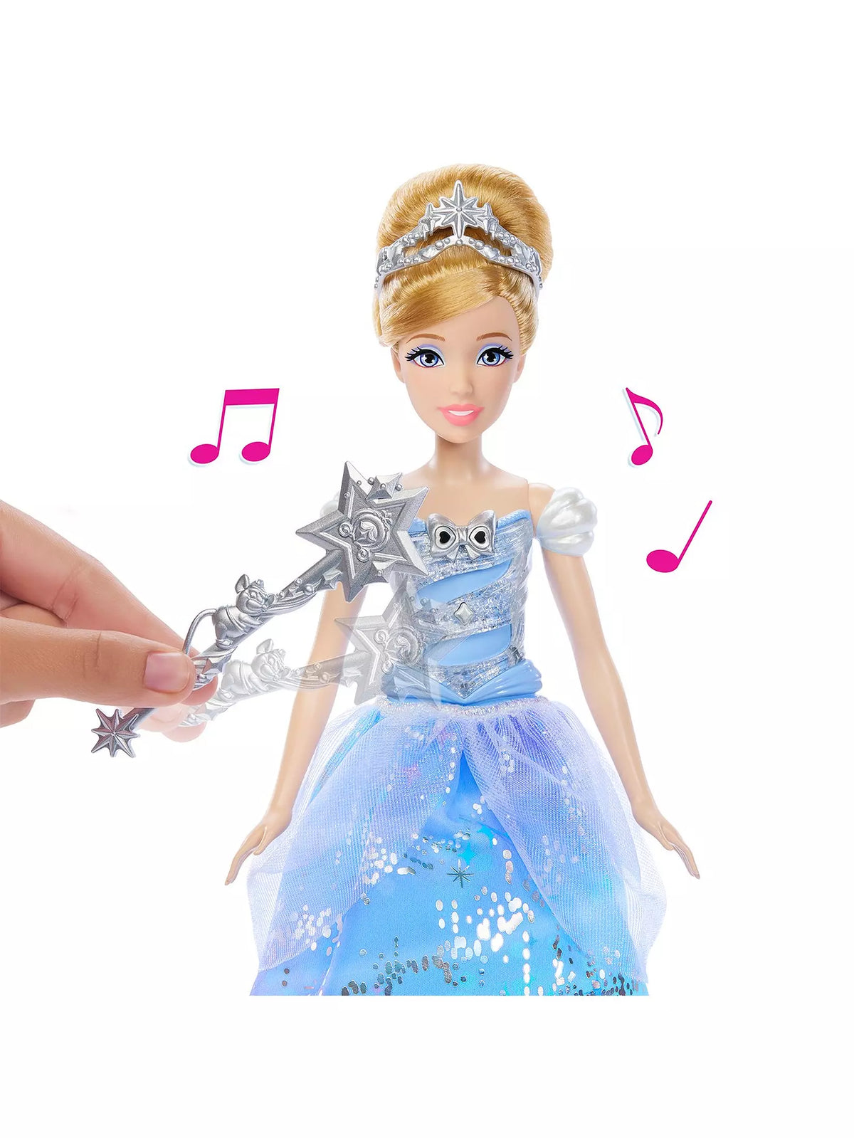 hand waving wand over doll in blue dress as music plays 