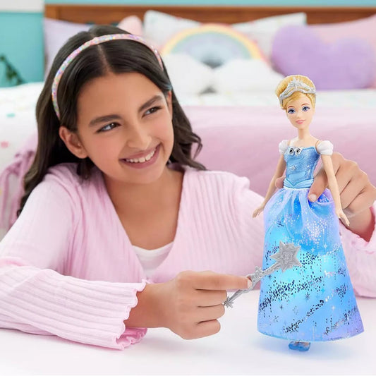 young girl smiling and playing with doll in blue dress 