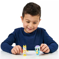young boy playing with two dog mini figures on white background 