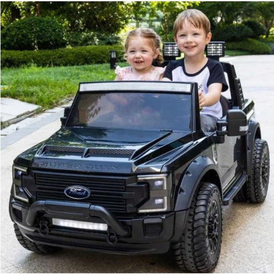 children playing on black ride-on truck 