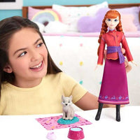 young girl playing with doll and wolf cub 