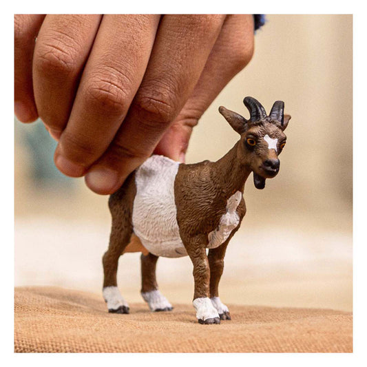 hand holding goat figure 