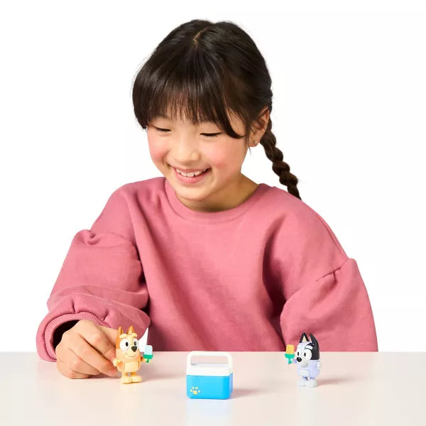 young girl playing with two dog mini figures 
